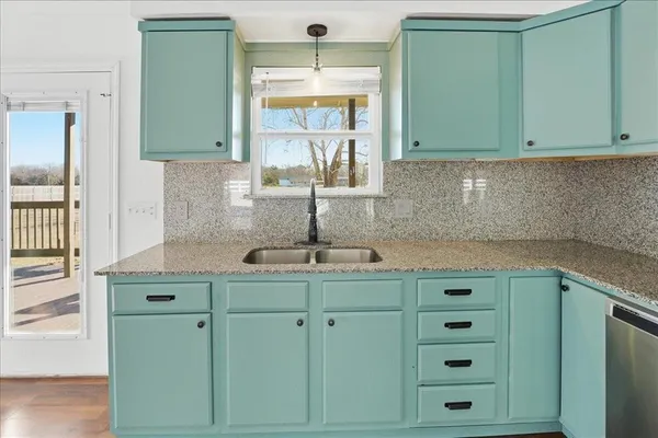 a kitchen with cabinets and window