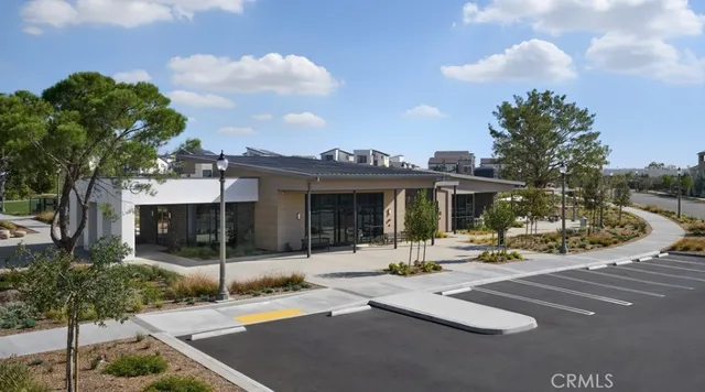 a view of a building with backyard and sitting area