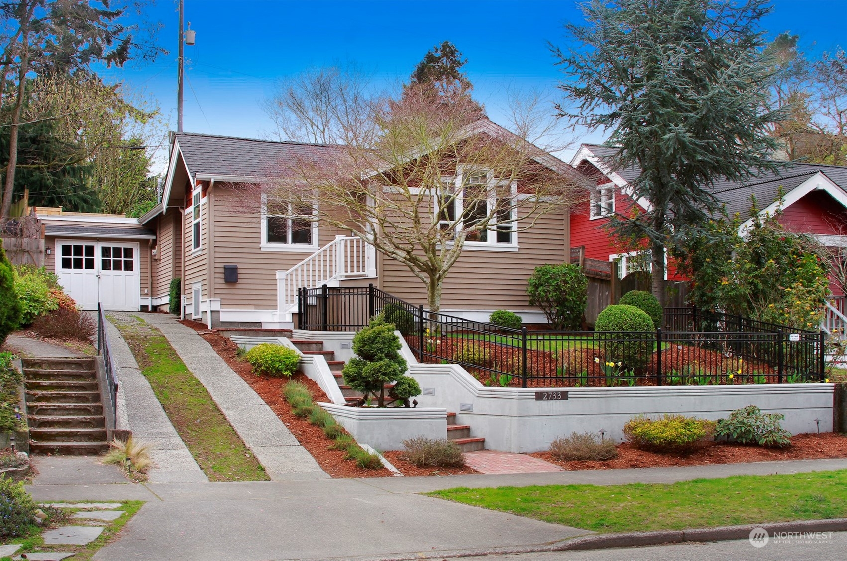 2733 49th Avenue Southwest Seattle, WA 98116 - Photo 1 of 32 a front view of a house with garden