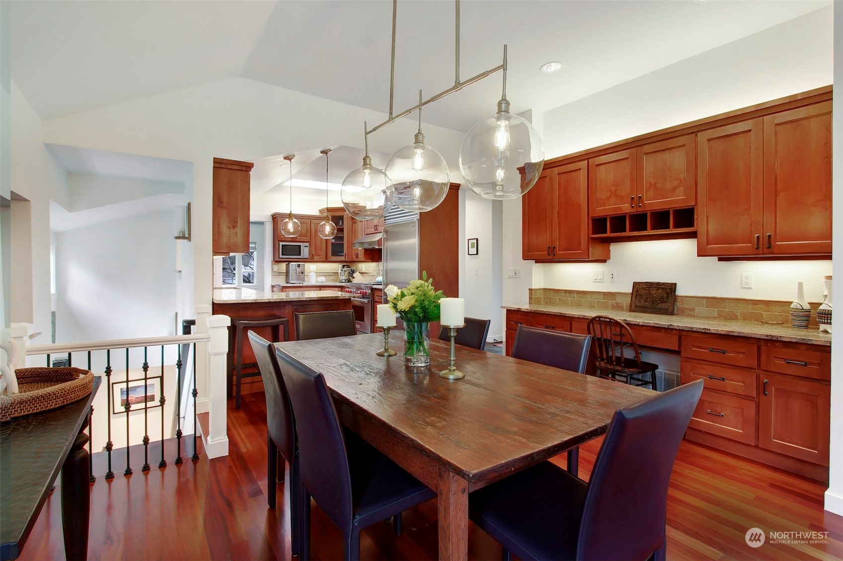 2733 49th Avenue Southwest Seattle, WA 98116 - Photo 11 of 32 a kitchen with stainless steel appliances a dining table chairs and granite counter tops