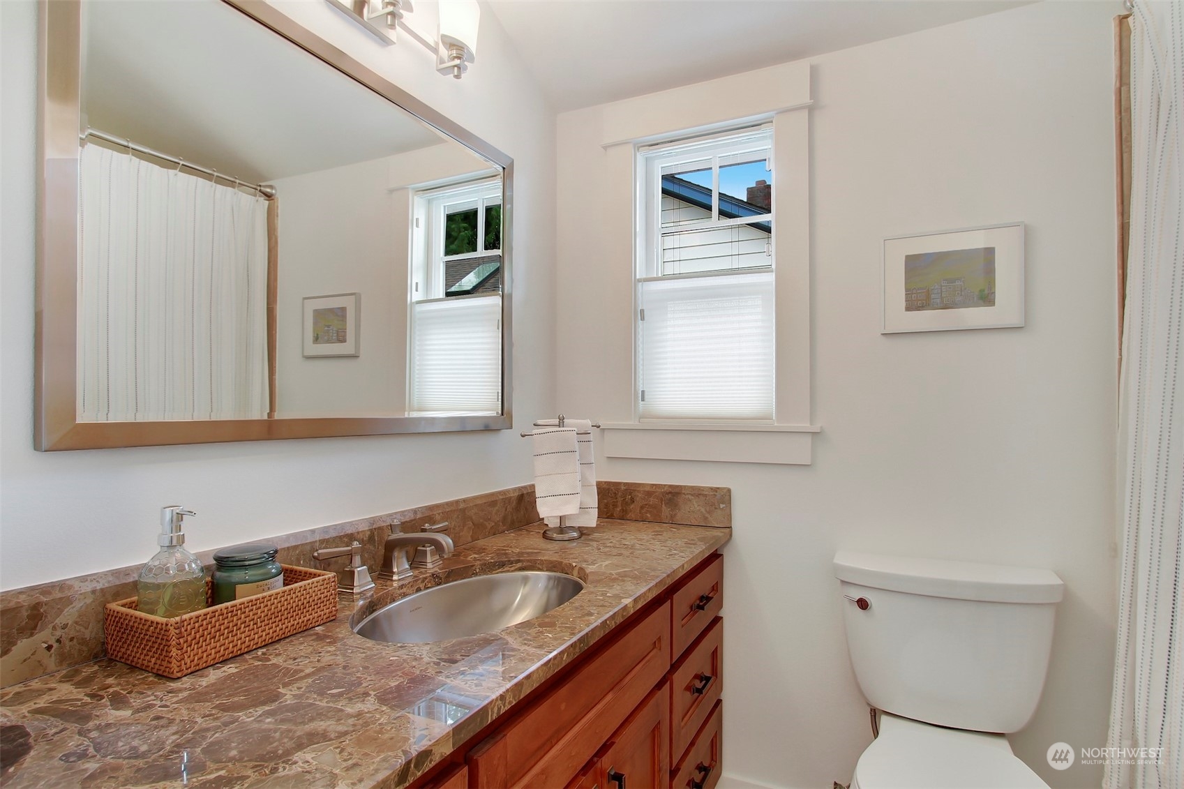 2733 49th Avenue Southwest Seattle, WA 98116 - Photo 22 of 32 a bathroom with a granite countertop toilet a sink and mirror