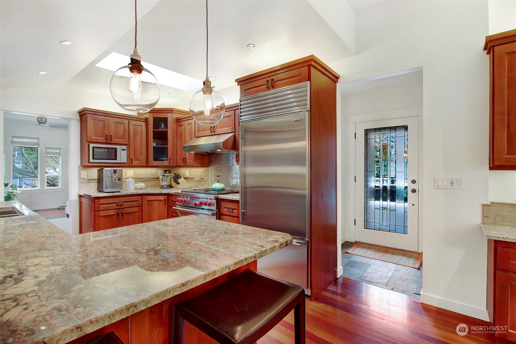 2733 49th Avenue Southwest Seattle, WA 98116 - Photo 10 of 32 a kitchen with stainless steel appliances granite countertop a refrigerator a stove and a wooden floors