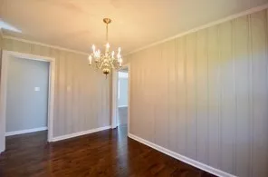 a view of a chandelier in big room and chandelier fan