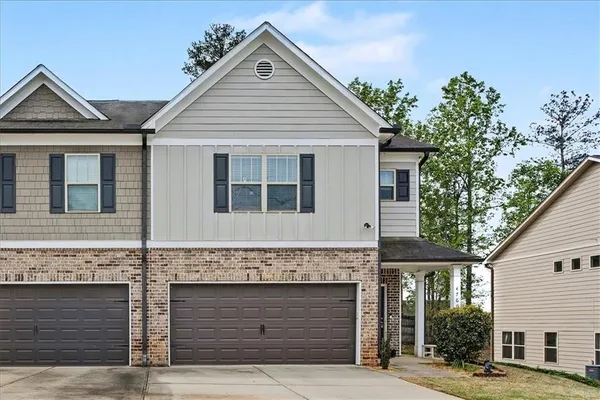 a front view of a house with garage