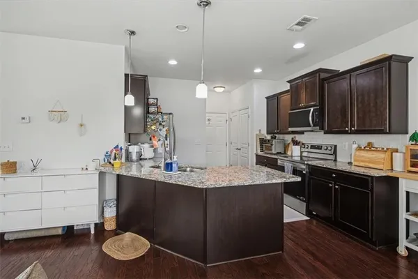 a kitchen with a sink stove and microwave
