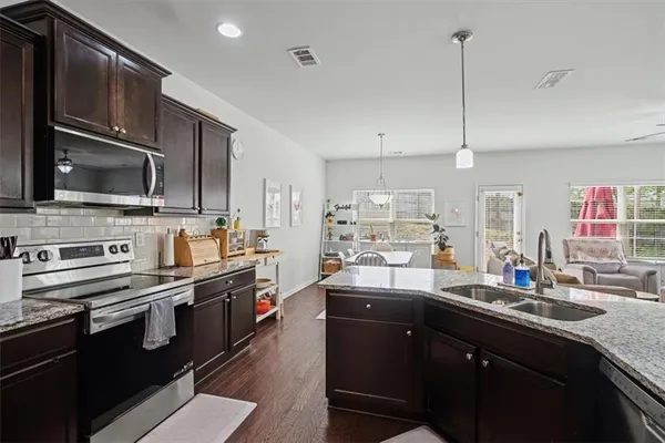a kitchen with stainless steel appliances a sink stove and refrigerator