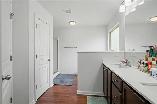 a bathroom with a sink double vanity and a mirror