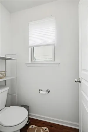 a white toilet sitting next to a bathroom sink