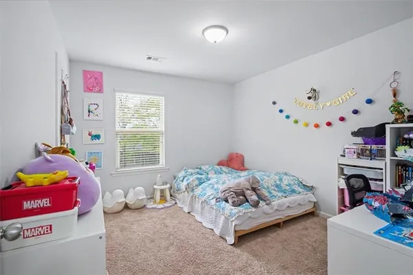 a bedroom with furniture a bed and a window