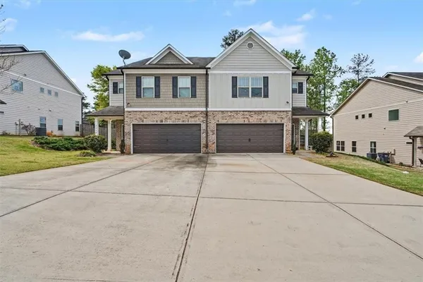 a view of house with yard in front of it