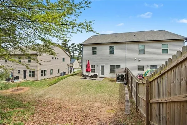 a view of a house with a yard and sitting area