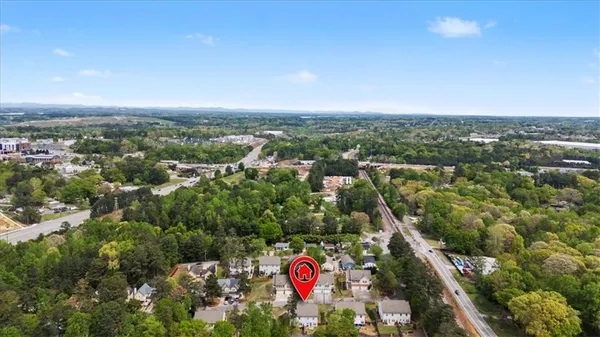 an aerial view of house with yard and mountain view in back