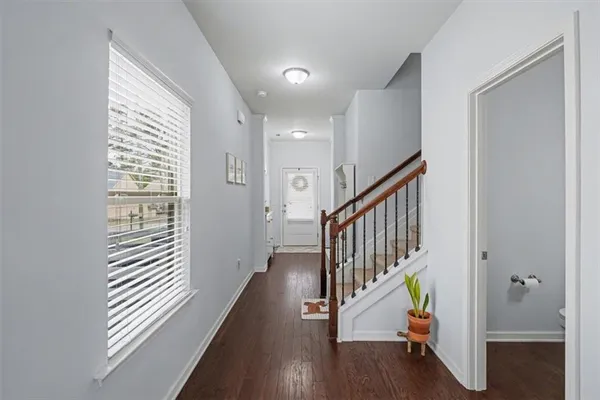 a view of entryway with wooden floor and stairs