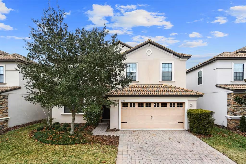 1424 Thunderbird Road Davenport, FL 33896 - Photo 1 of 22 a front view of a house with a yard and garage