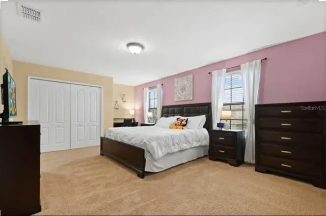 a bedroom with a bed and a baby