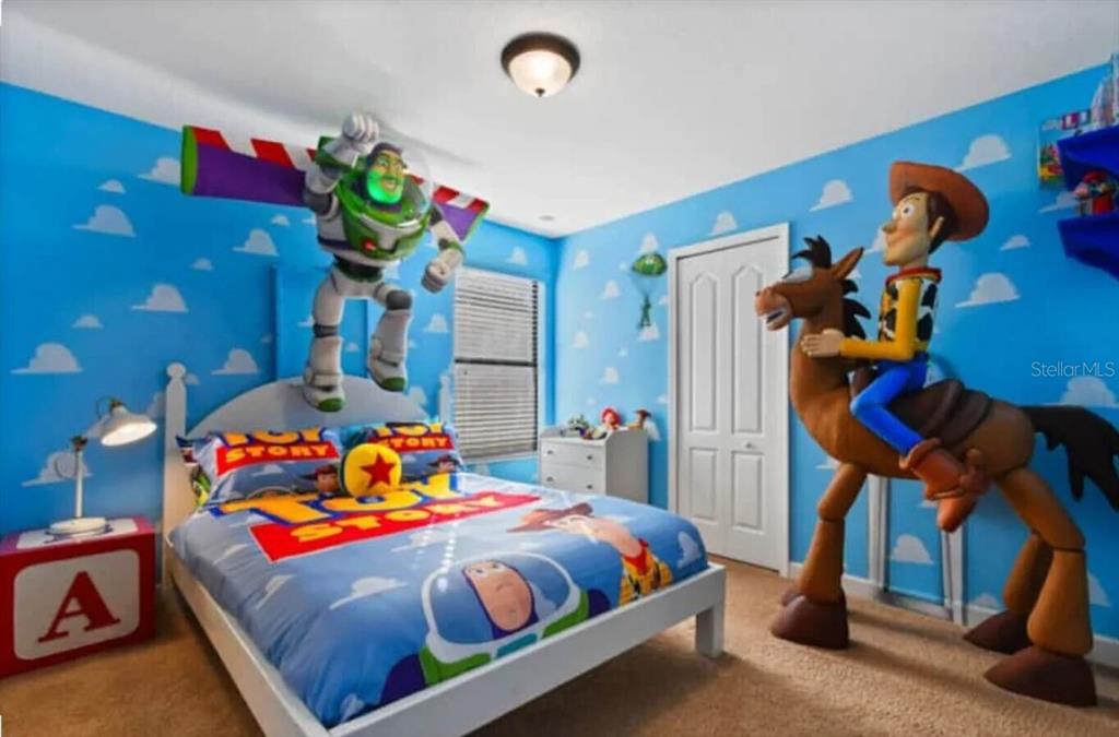 1424 Thunderbird Road Davenport, FL 33896 - Photo 13 of 22 a bedroom with two beds and a potted plant