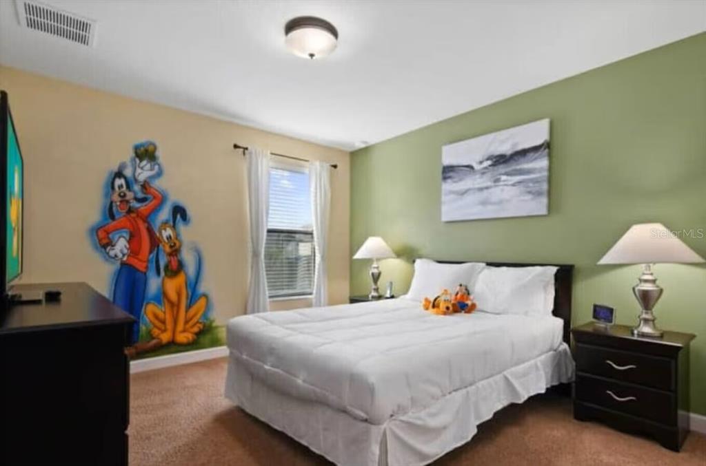 1424 Thunderbird Road Davenport, FL 33896 - Photo 9 of 22 a bedroom with a bed and a painting on the wall