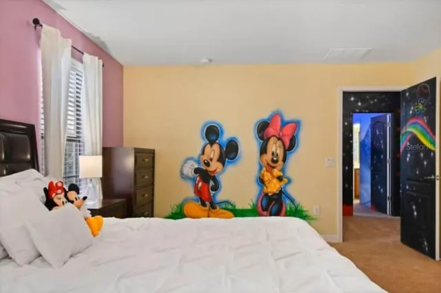 a bedroom with a bed and a television