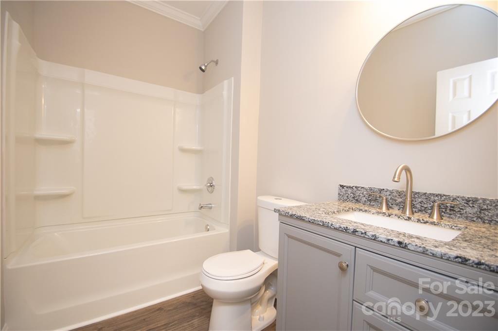 1257 Springdale Road Lancaster, SC 29720 - Photo 15 of 18 a bathroom with a granite countertop sink toilet and shower