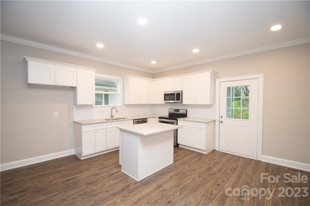 1257 Springdale Road Lancaster, SC 29720 - Photo 7 of 18 a kitchen with cabinets and wooden floor