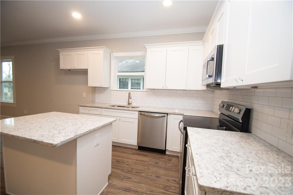 1257 Springdale Road Lancaster, SC 29720 - Photo 9 of 18 a kitchen with a sink stove and cabinets