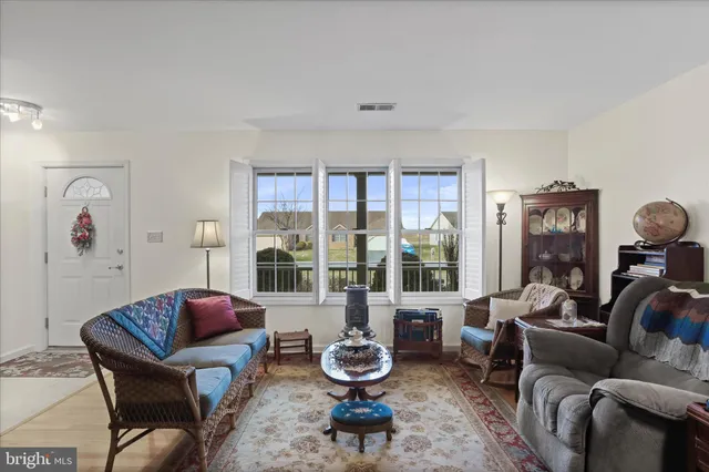 a living room with furniture and a floor to ceiling window