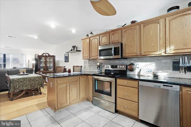 a kitchen with stainless steel appliances granite countertop a sink and cabinets