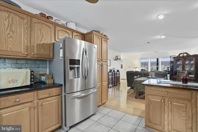 a kitchen with refrigerator and cabinets