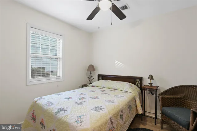 a large bed sitting in a bedroom next to a window