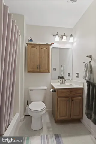 a bathroom with a toilet sink and mirror