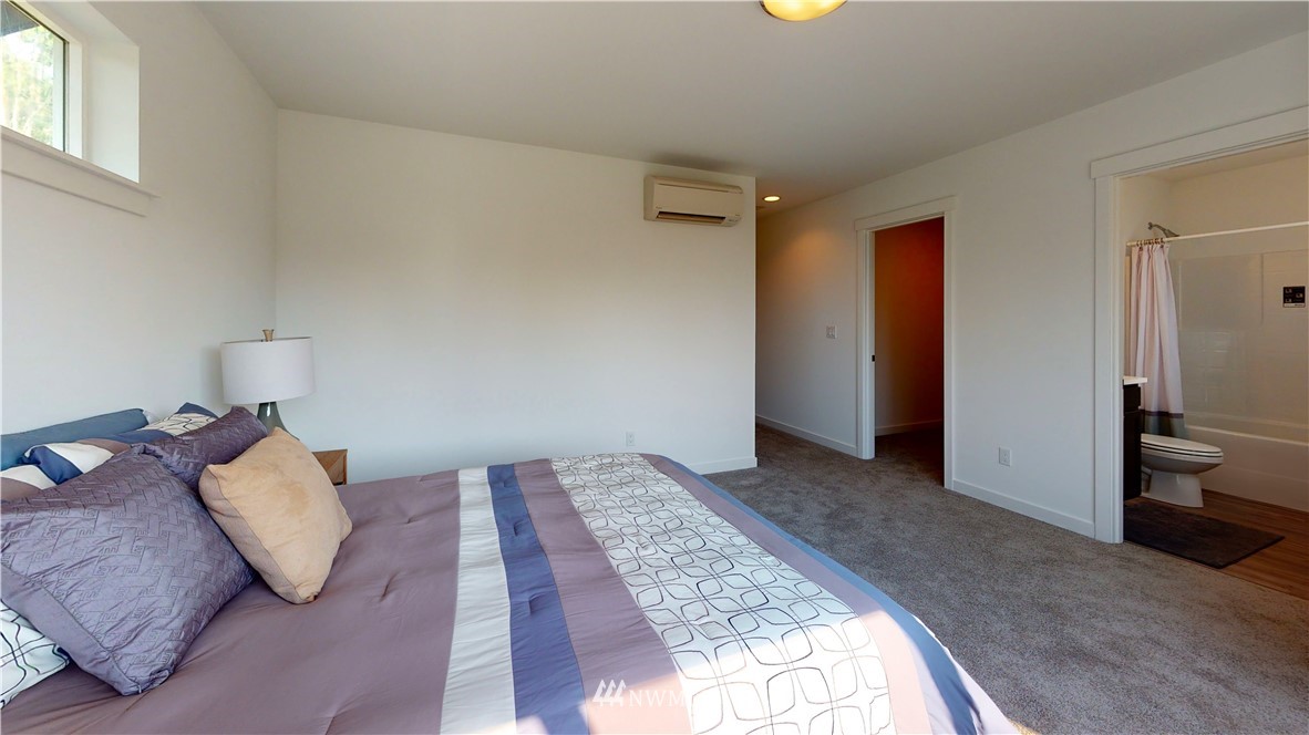 4865 Talbot Road South, Unit B4 Renton, WA 98055 - Photo 27 of 33 a spacious bedroom with a bed and wooden floor