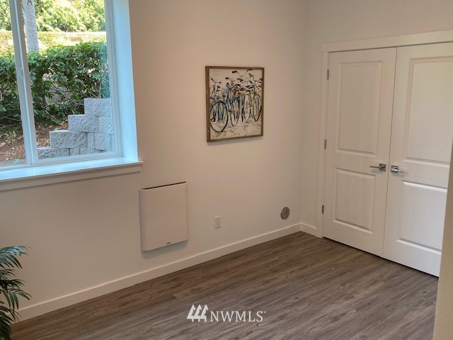 4865 Talbot Road South, Unit B4 Renton, WA 98055 - Photo 32 of 33 an empty room with wooden floor and windows