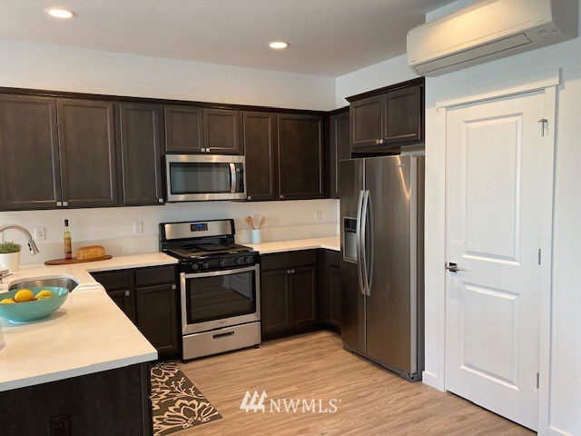 4865 Talbot Road South, Unit B4 Renton, WA 98055 - Photo 7 of 33 a kitchen with a refrigerator stove and microwave