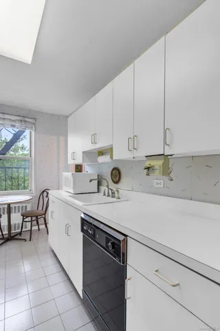a kitchen with a sink cabinets and window