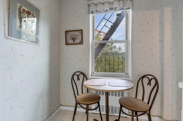 a view of a dining room with furniture and a window