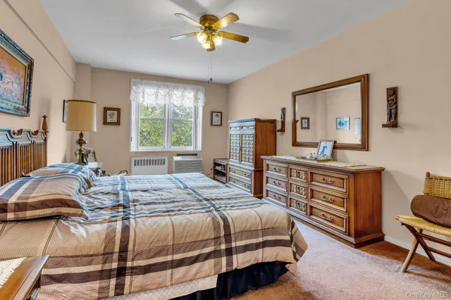 a bedroom with a bed dresser and a window