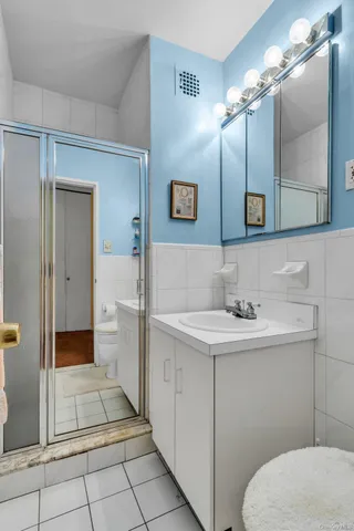 a bathroom with a toilet a sink and mirror
