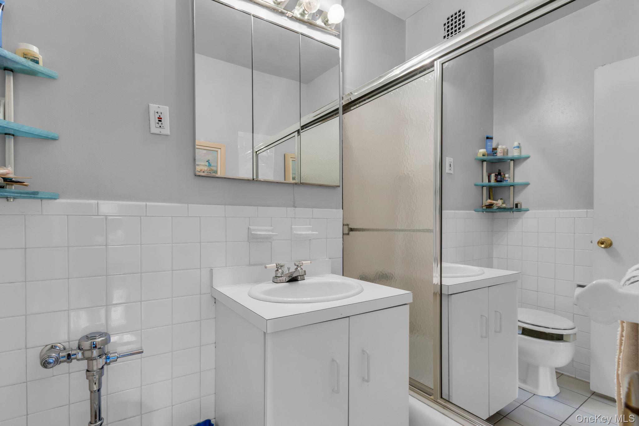 3901 Independence Avenue, Unit 4R Bronx, NY 10463 - Photo 25 of 35 a bathroom with a sink a toilet and shower