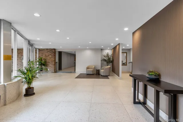 a lobby with a couch and potted plants