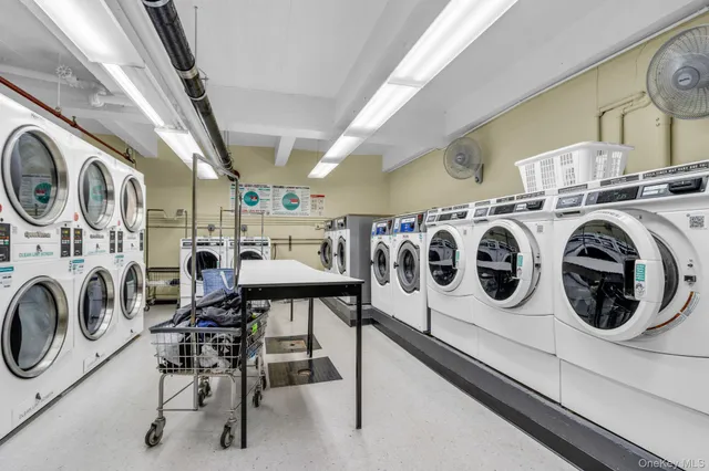 a utility room with dryer washer and a view of kitchen