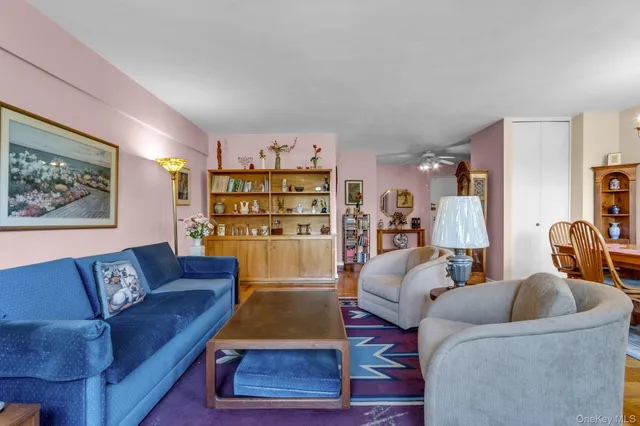 a living room with furniture a rug and a bookshelf