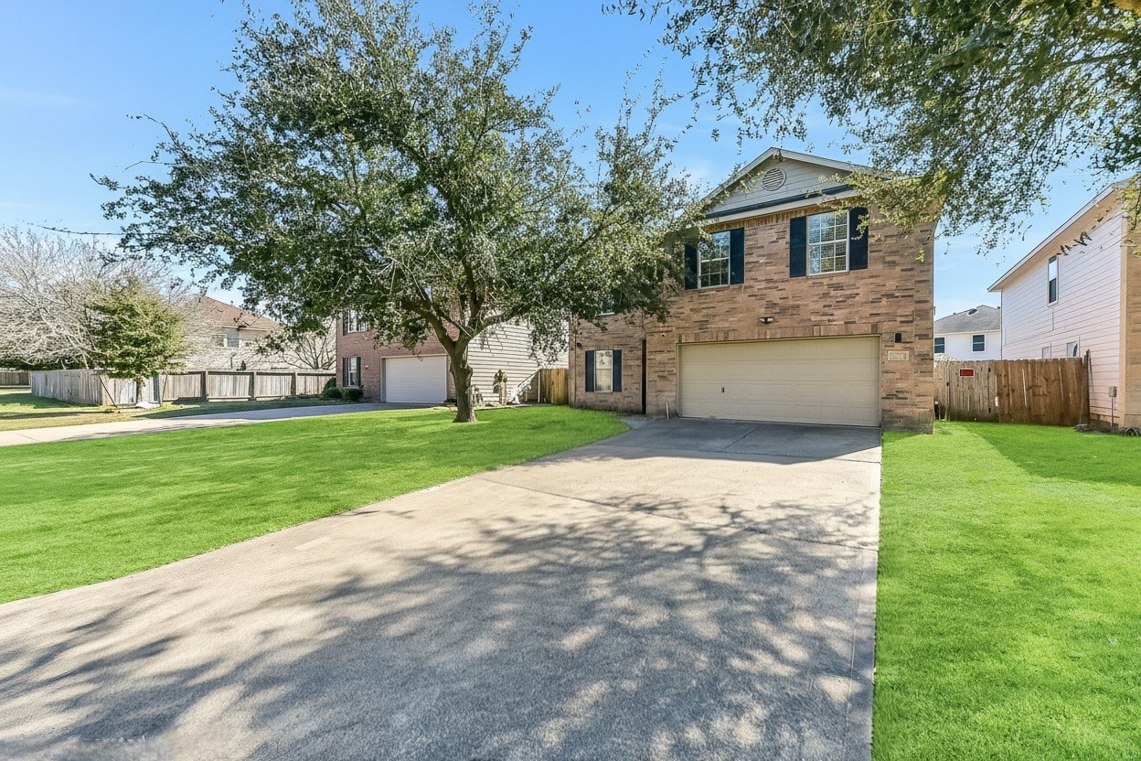 a front view of house with yard and green space