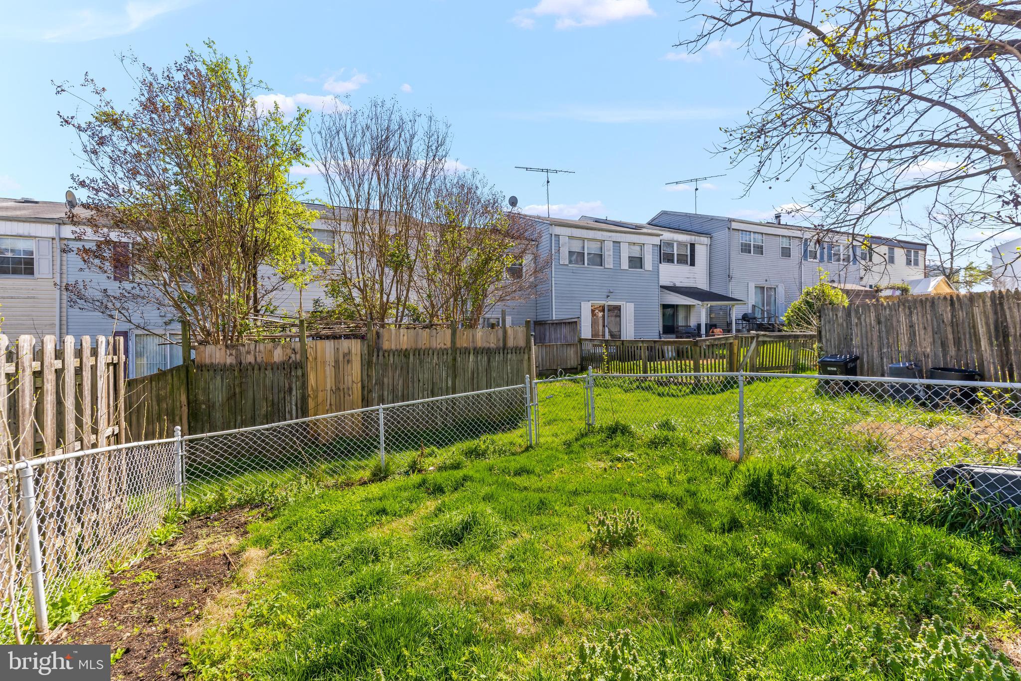 15 Bohn Court Rosedale, MD 21237 - Photo 30 of 31 a backyard of a house with lots of green space and fountain