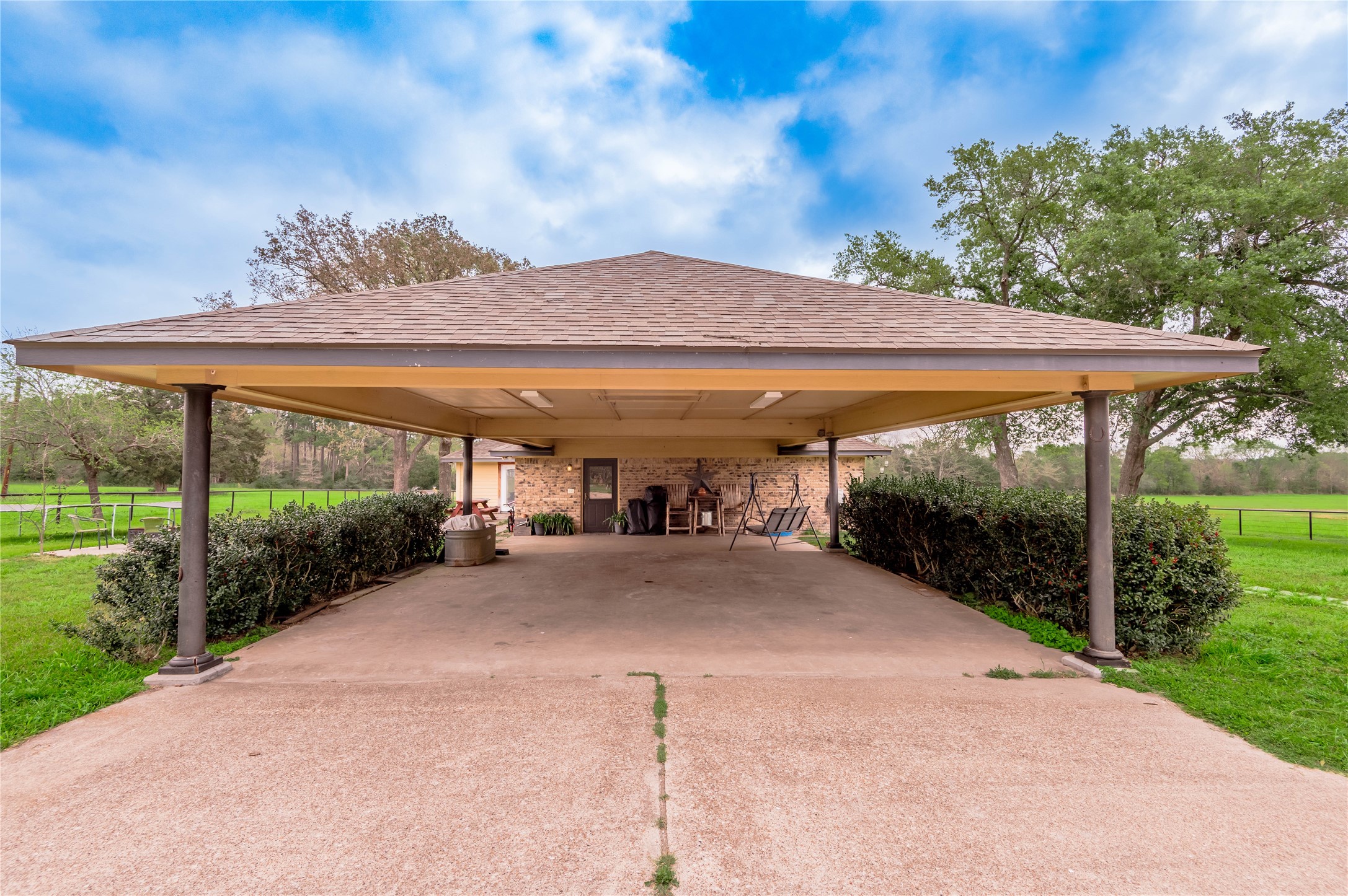 758 Wire Road Huntsville, TX 77320 - Photo 26 of 44 a view of a patio with a table and chairs under an umbrella with a big yard