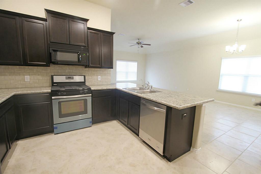 722 Mill Spring Court Rosenberg, TX 77469 - Photo 2 of 11 Whirlpool dishwasher and gas range.