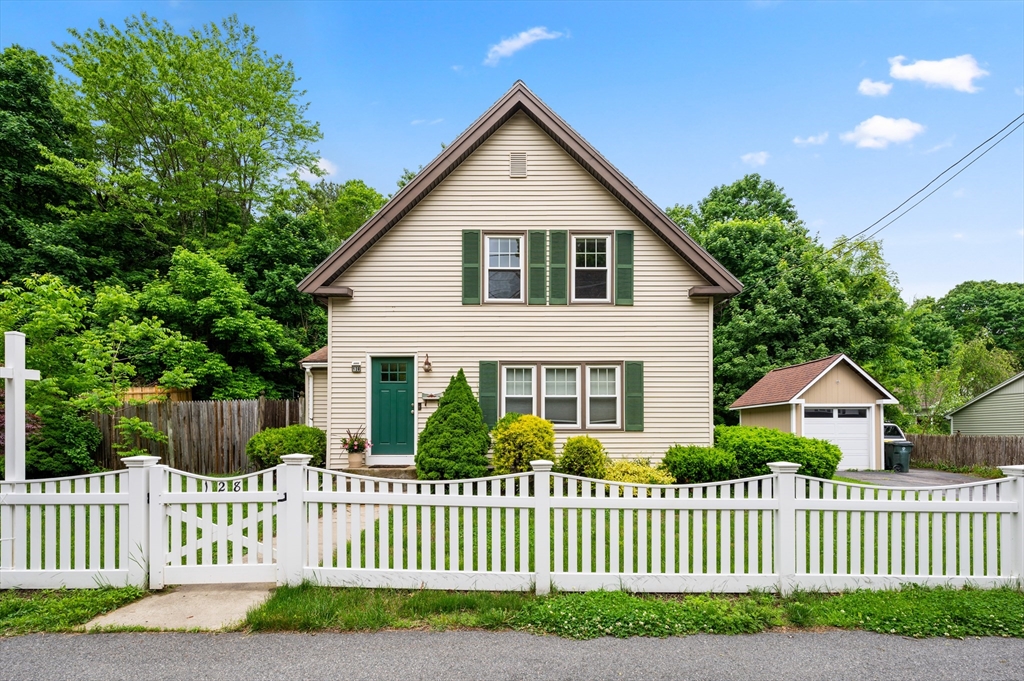 a front view of a house with wooden fence
