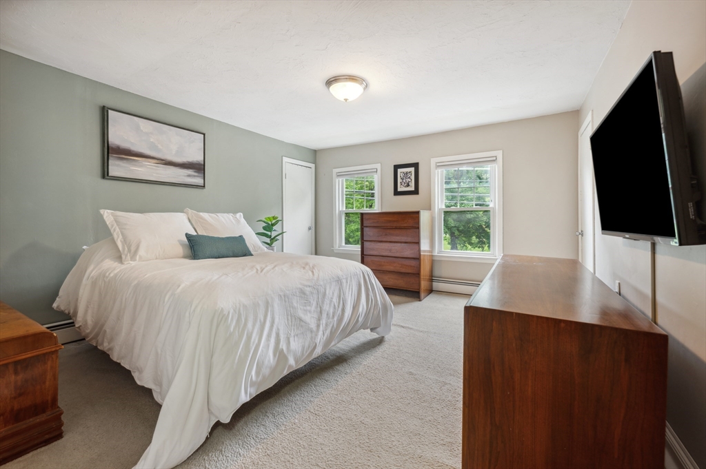 128 Pleasant Street Franklin, MA 02038 - Photo 11 of 19 a bedroom with a bed tv and a window