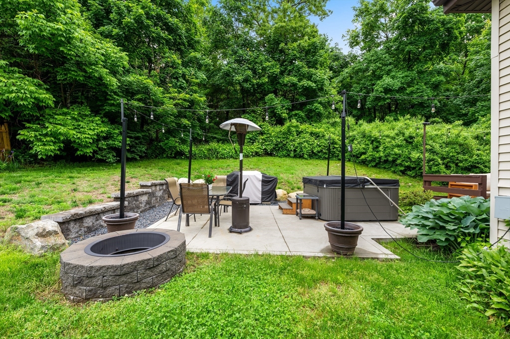 128 Pleasant Street Franklin, MA 02038 - Photo 19 of 19 an outdoor sitting area with chairs and a table
