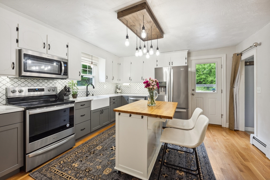 128 Pleasant Street Franklin, MA 02038 - Photo 4 of 19 a kitchen with stainless steel appliances granite countertop a sink stove and refrigerator