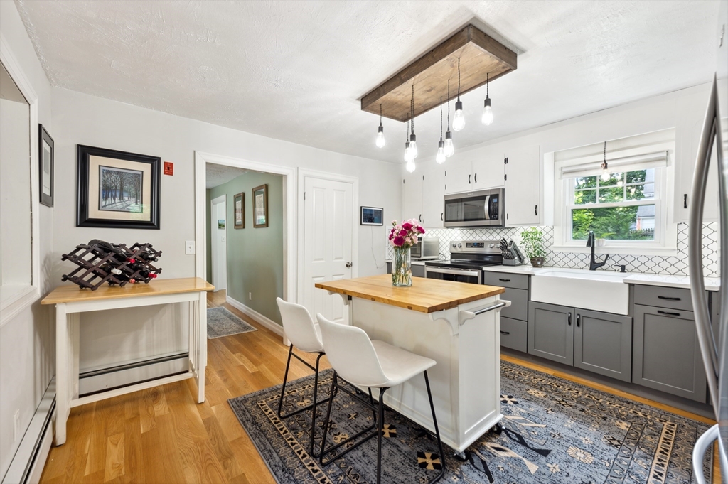 128 Pleasant Street Franklin, MA 02038 - Photo 5 of 19 a kitchen that has a sink and a stove in it